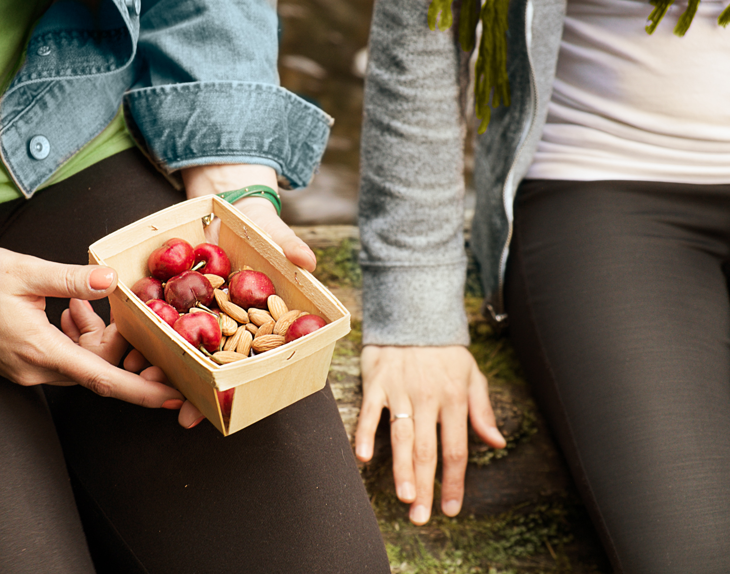 woman holding a box of strawberries