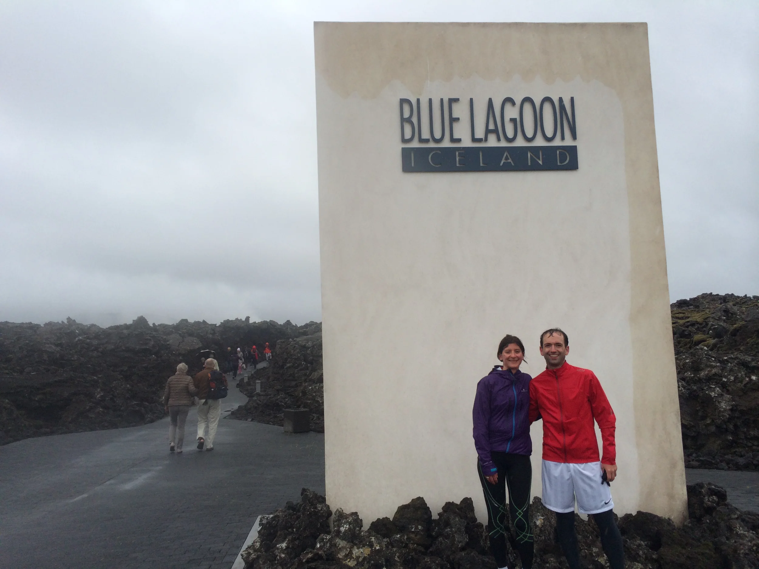 Standing in front of a big Blue Lagoon badge
