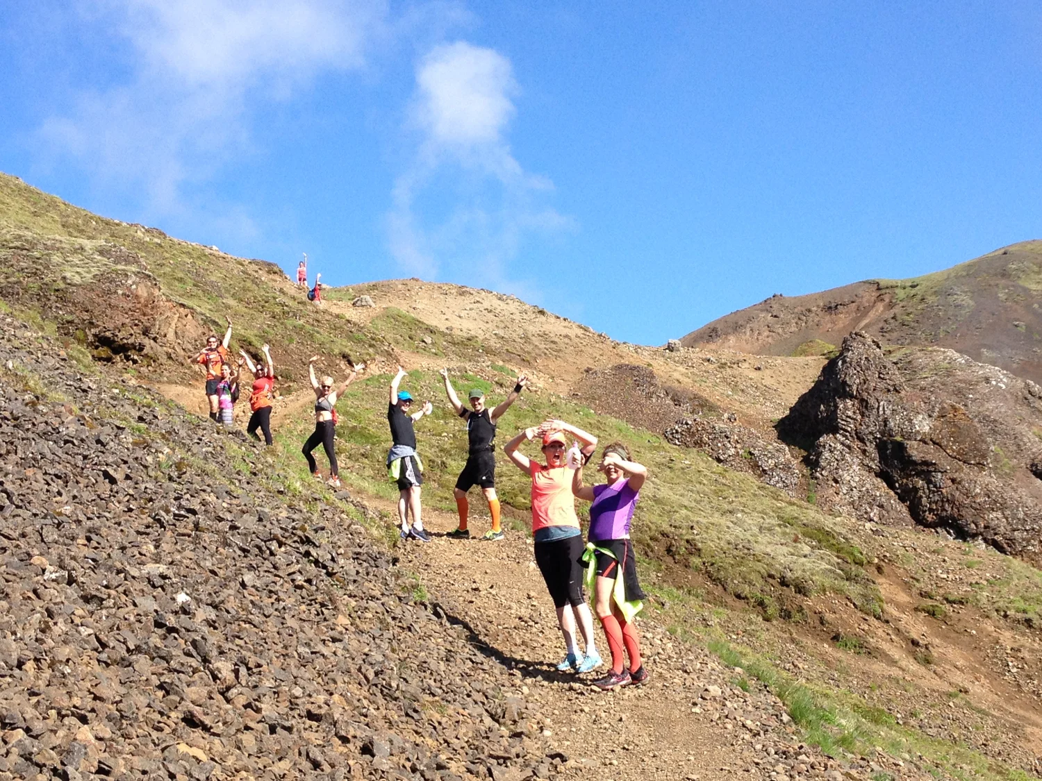 Runners waving in Reykjadalur