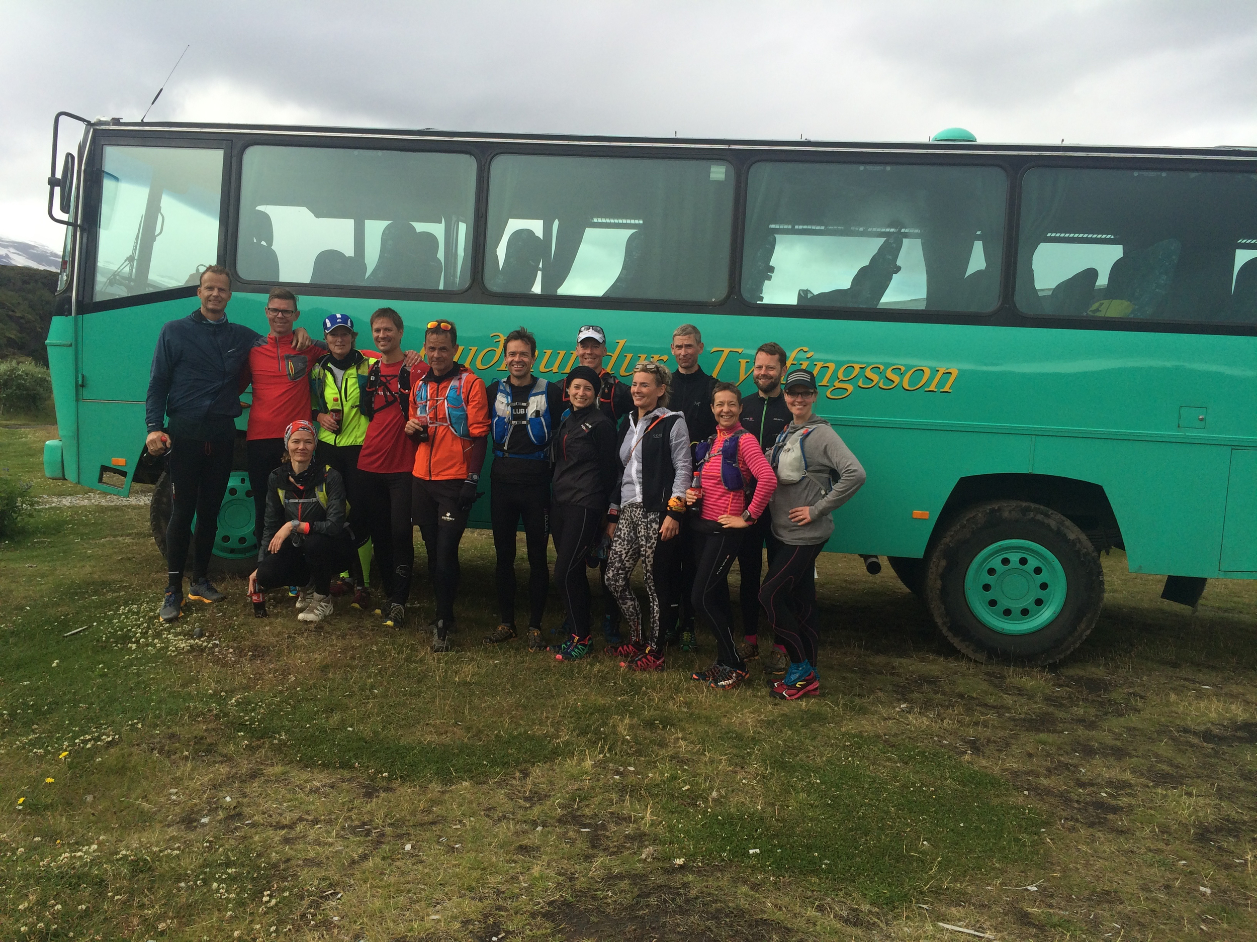 A running group in front of a bus