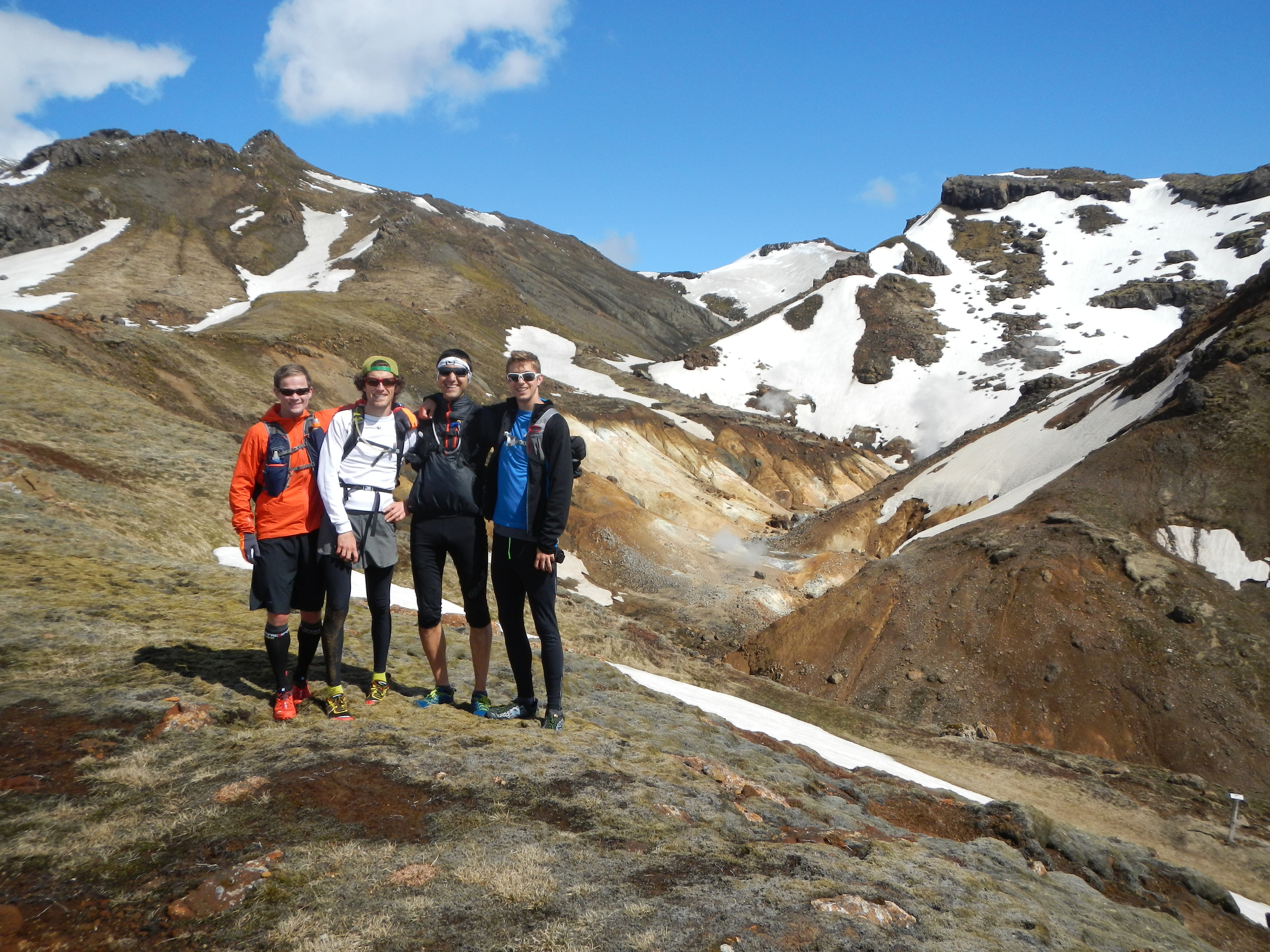 Four man standing on a mountain ridge