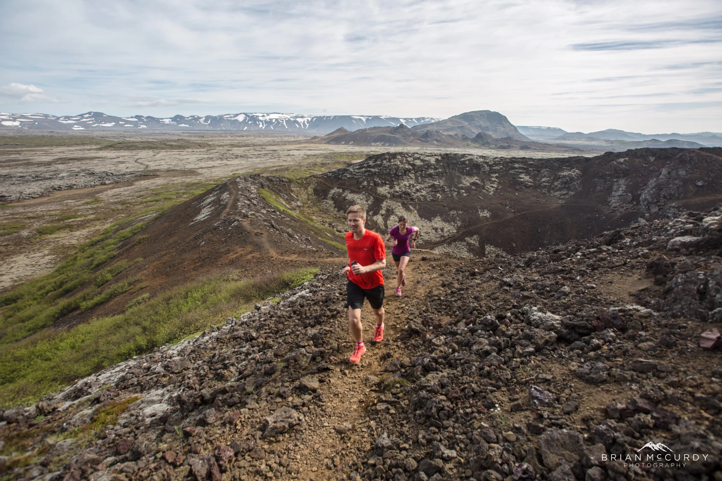 Running with a crater in the background