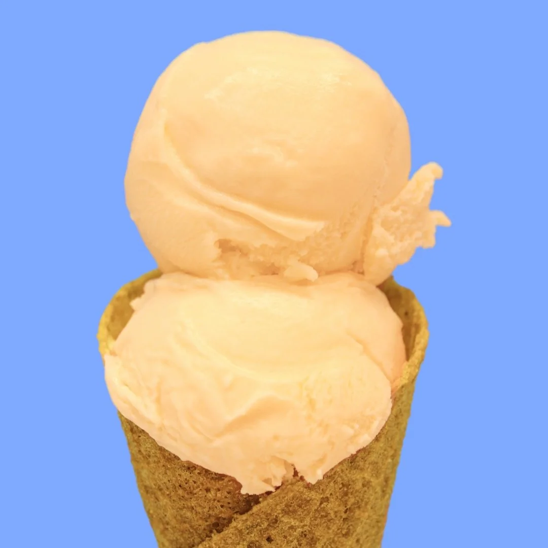 Orange Creamsicle Sherbet in front of a blue background