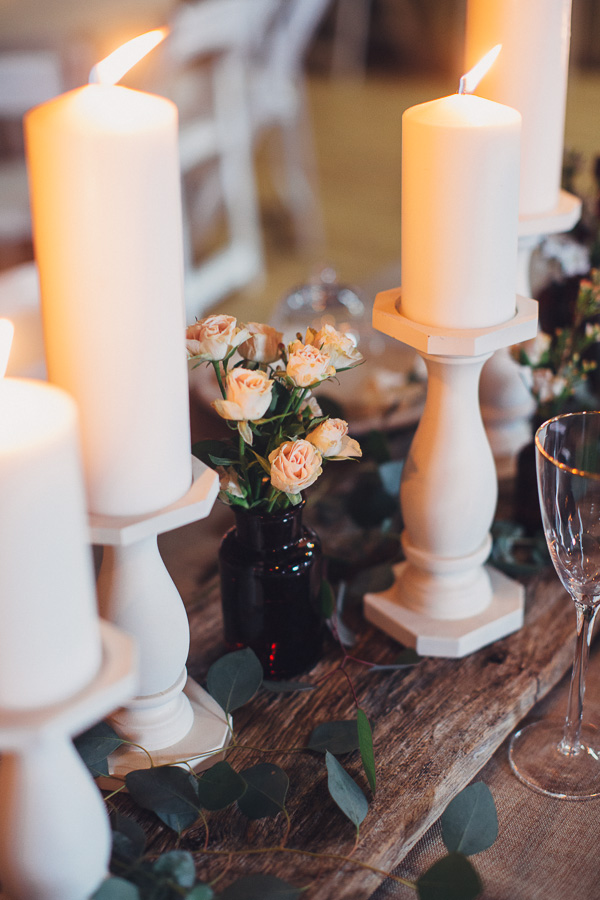 (White pillar candles on barnwood) Maile Lani Photography