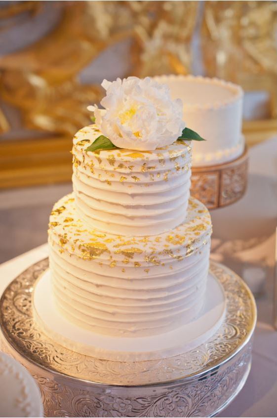  two tier white wedding cake with gold flake 