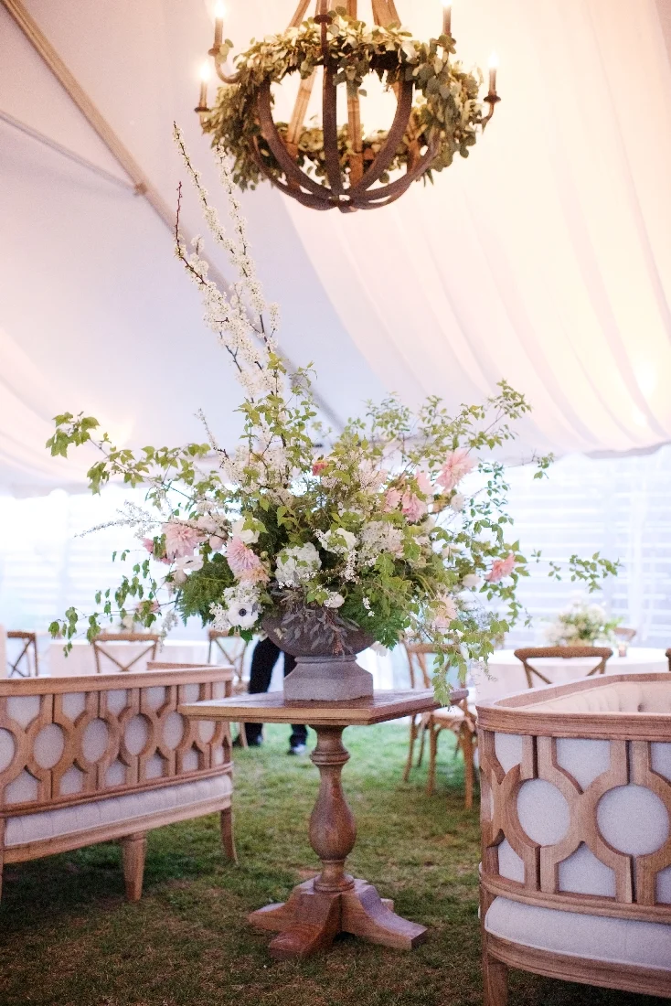 large centerpiece under wooden chandelier.jpeg