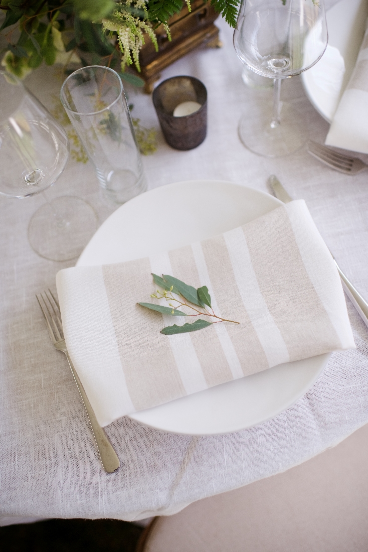 reception table with stripe napkins greenery.jpeg