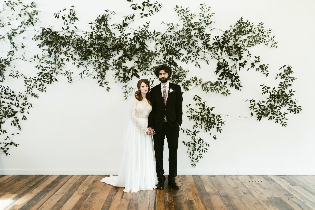 bride and groom greenery wall.jpeg