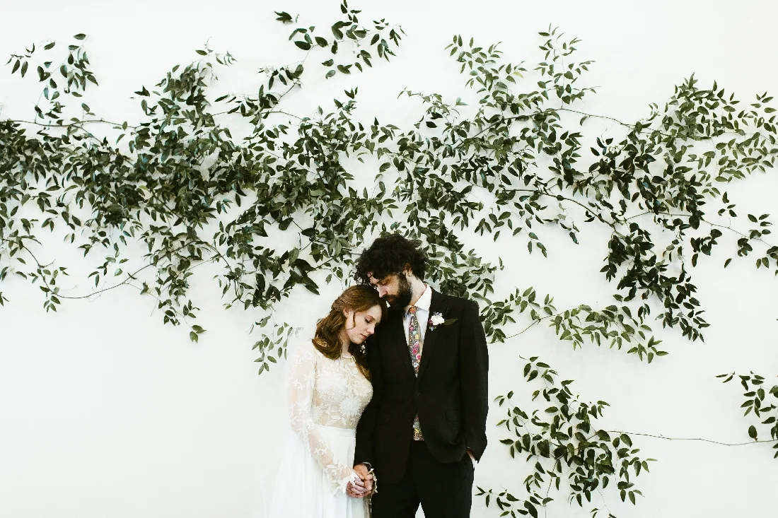 greenery wall wedding couple.jpeg