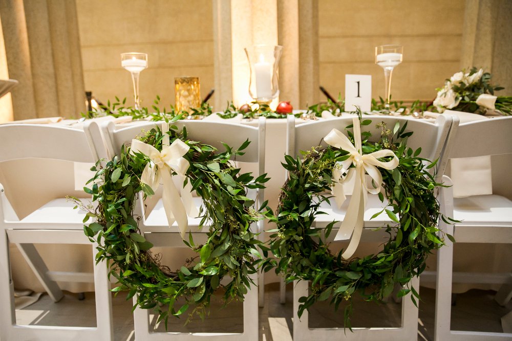 greenery wreaths on bride and groom chair.jpg