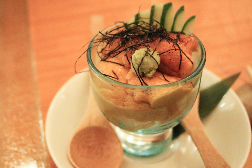 Uni Cup, Rice at the bottom, five tongues piled one atop another with grilled scallop aside with cucumber, wasabi, and nori flakes on top