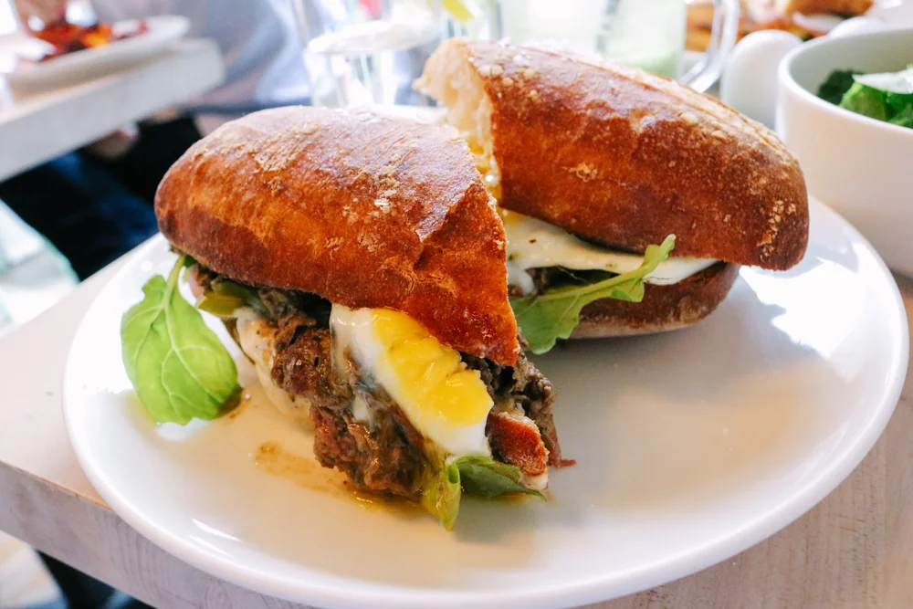 Steak and Egg, Grass Fed Tenderloin, Sunny up, Chimi-Chilli, Caramelized Onion Aioli, Farm Greens, French Hero