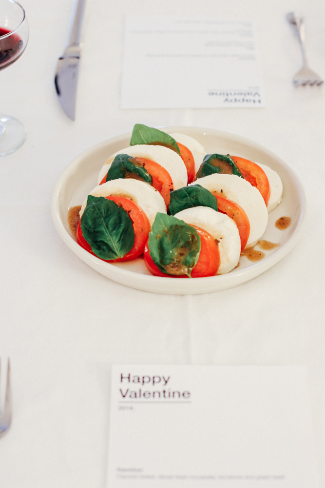 Caprese Salad, sliced fresh mozarella, tomatoes and green basil