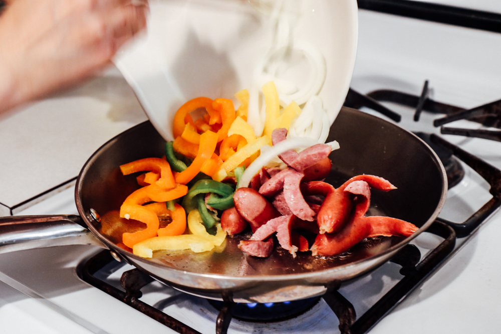 Add onion and peppers, and cook for a minute or two.