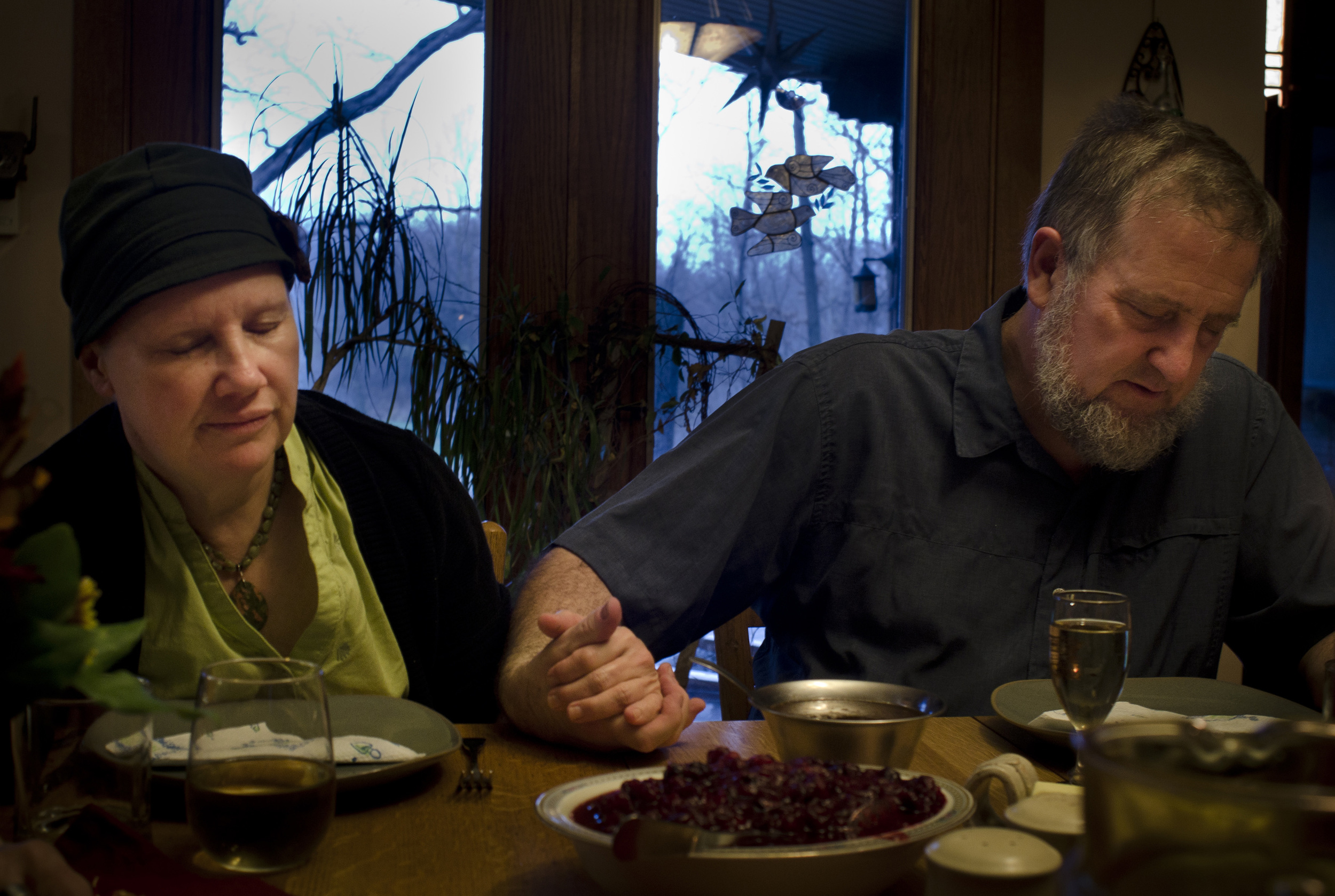 Lois and Jeff take a moment to pray before dinner. They have struggled through the process of battling cancer together even though it has caused a strain in their relationship.