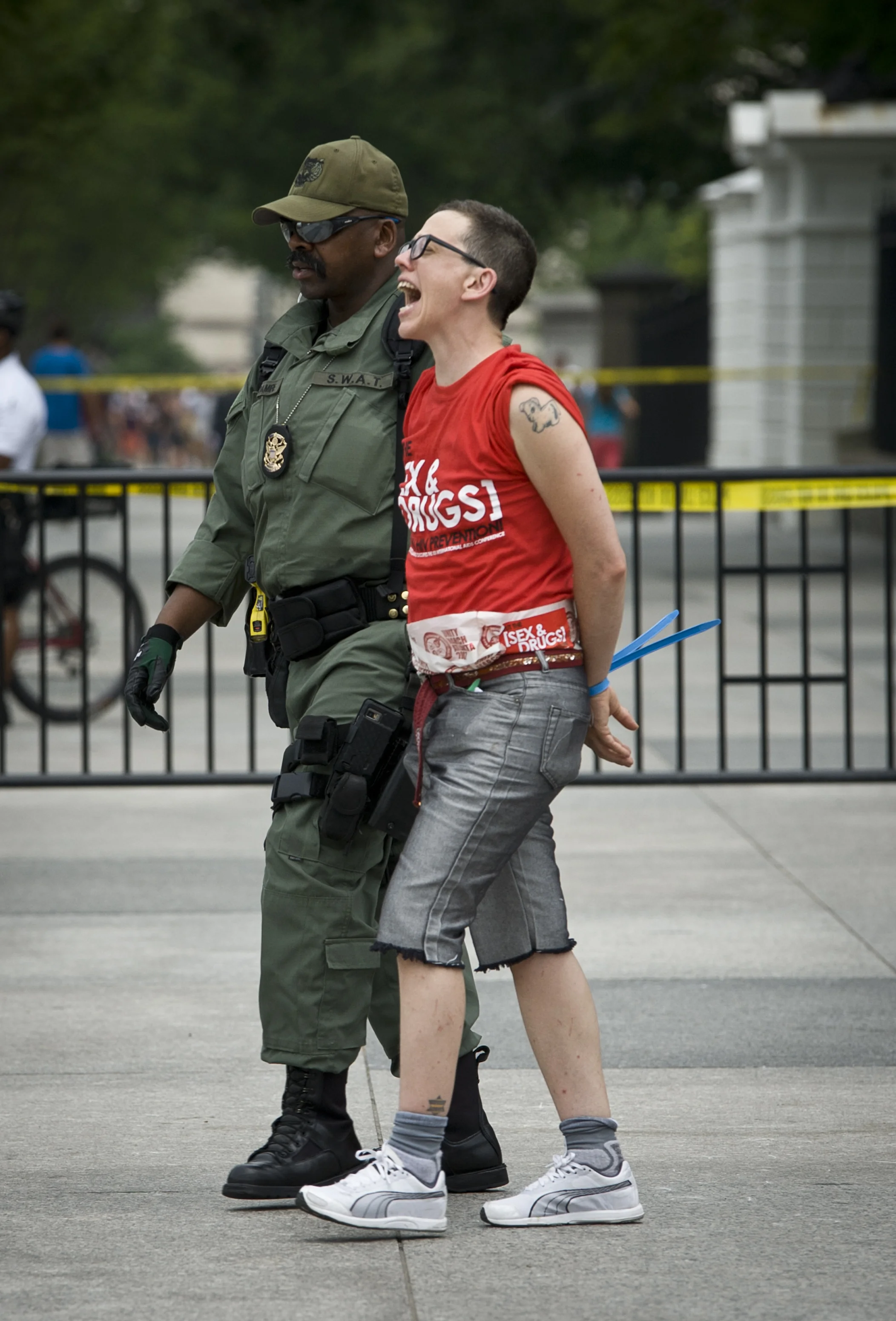  A participant of the AIDS/HIV Rally is arrested in front of the White House in Washington D.C. on July 24, 2012. The rally was organized to bring awareness to the stigmatization and rising drug prices surrounding the AIDS/HIV crisis. 