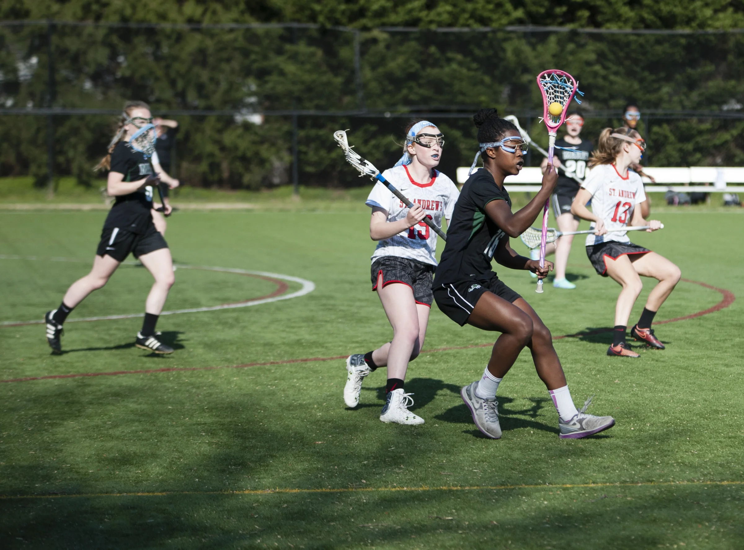 Maret School lacrosse player (16) works to keep the ball away from Adrienne Fine (19) a defender for St. Andrews Episcopal School on April 14, 2016 in Potomac, MD. St. Andrews Episcopal School beat Maret School 20-8.