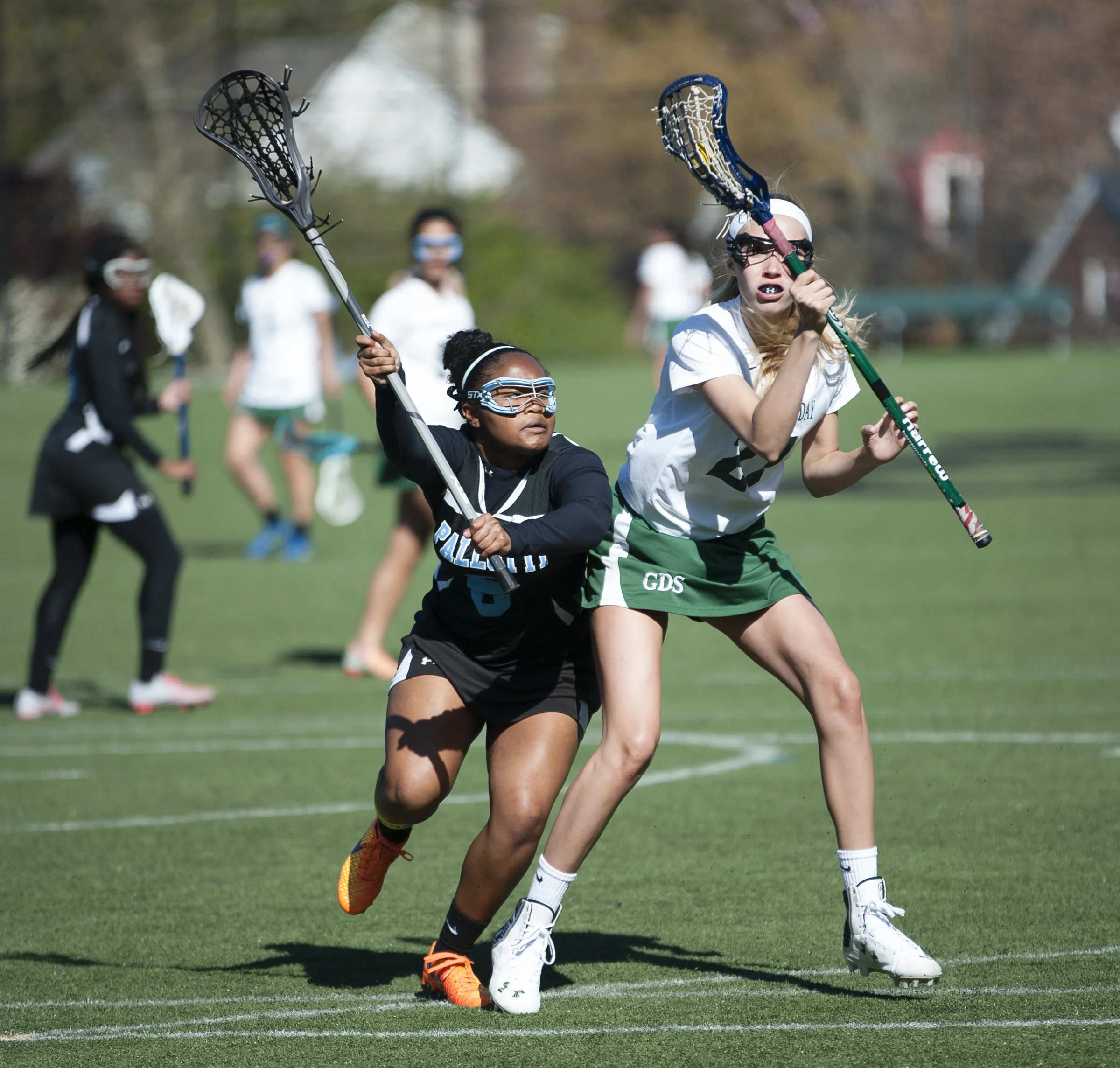 St. Vincent Pallotti High School defender (8) works to stop Maddie Asher (21) of Georgetown Day School on April 16, 2016. St. Vincent Pallottie High School lost 10-9 in overtime to Georgetown Day School.