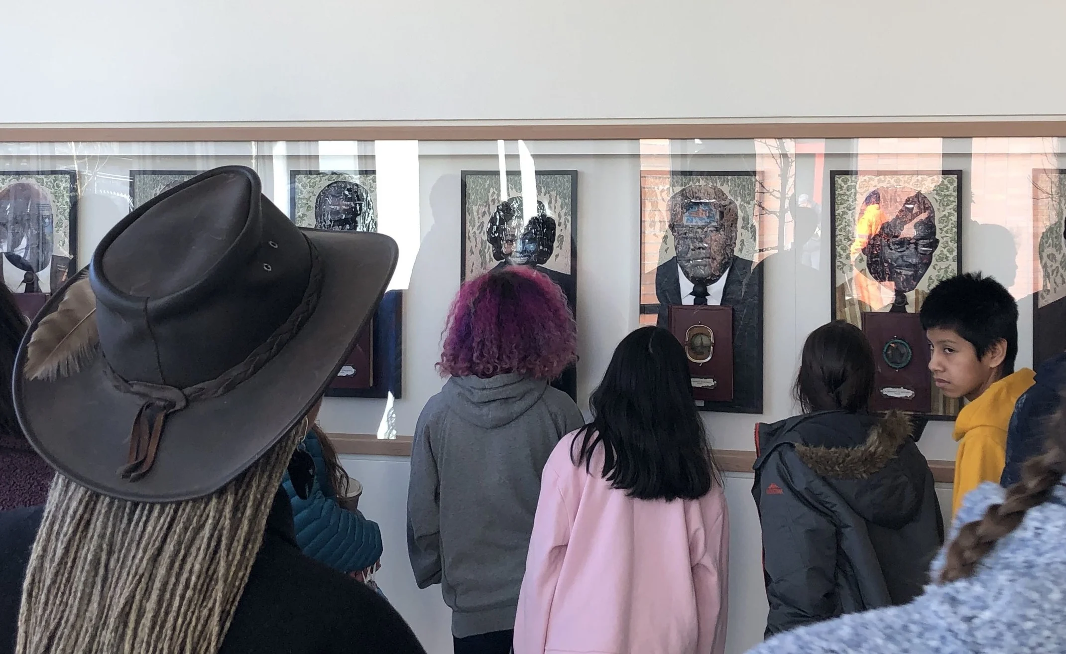 Curator Esther Ervin (wearing hat) leads Redmond,WA students on a Liberty Bank Bldg art tour. Credit: Jackie Peterson