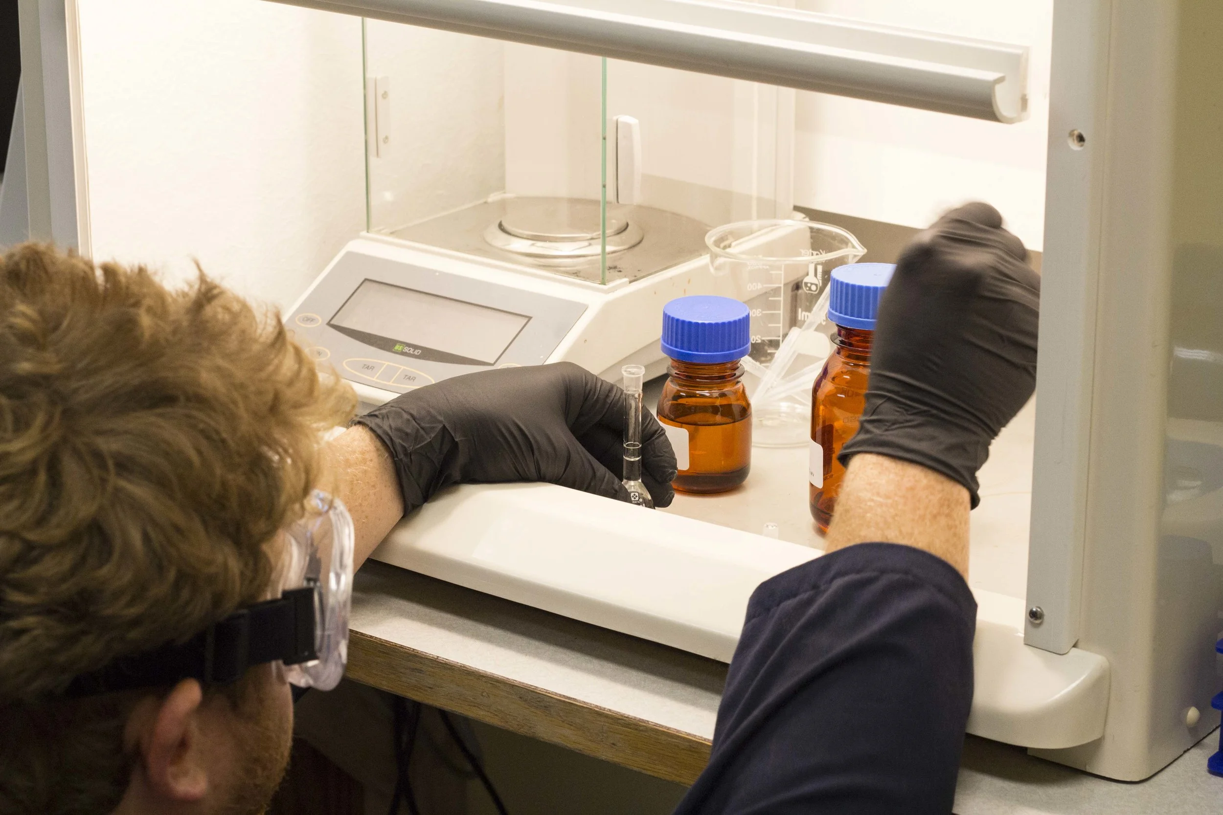 Adding reagents to beer distillate to initiate reaction.
