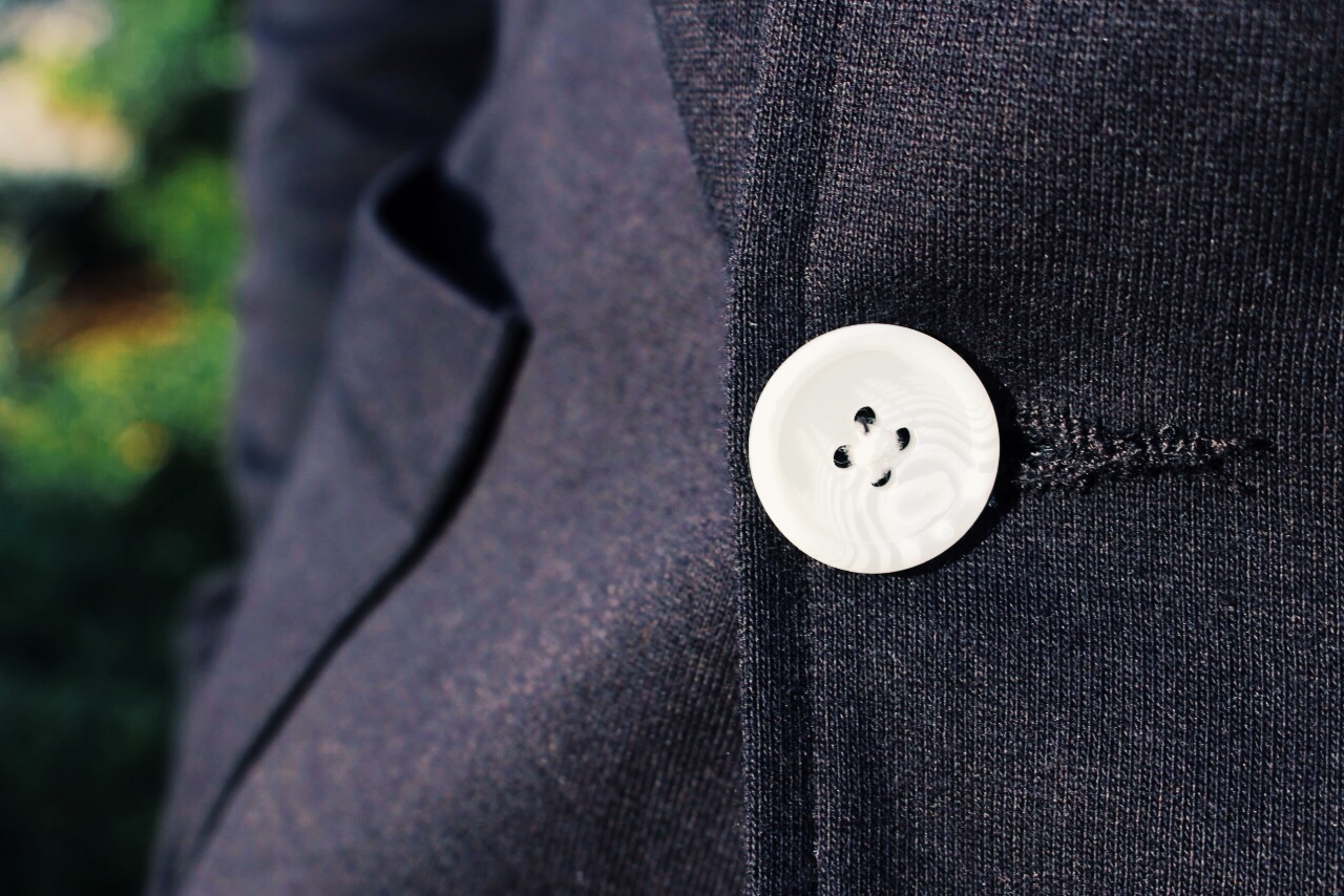 Details count. These white buttons pop with stark contrast against this H&M black blazer.