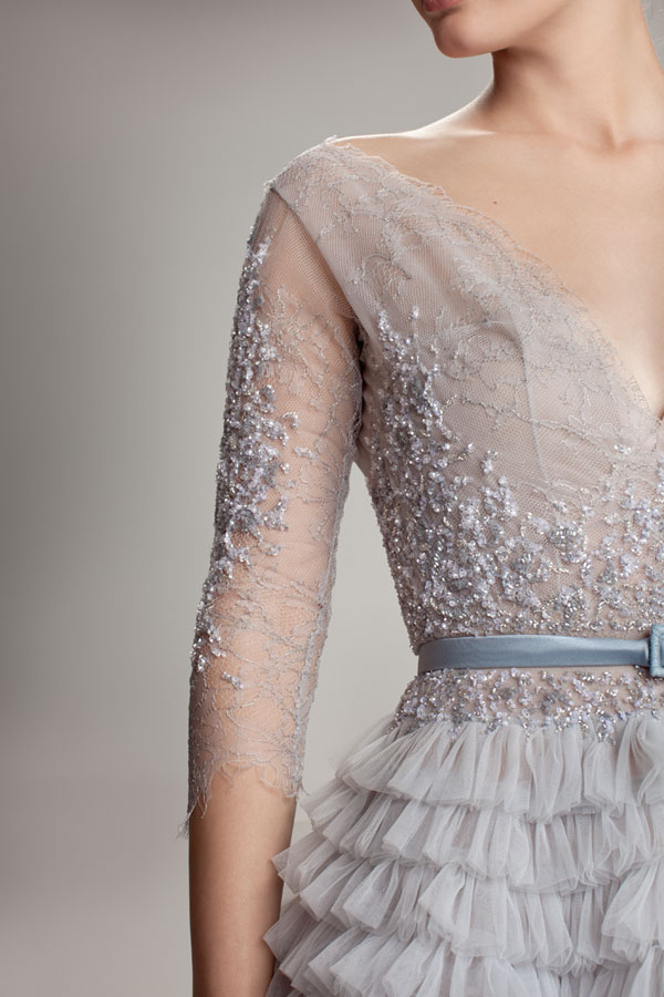 The gorgeous intricate beading and embroidery on this gown's lace sleeves and bodice add to its ethereal feel.