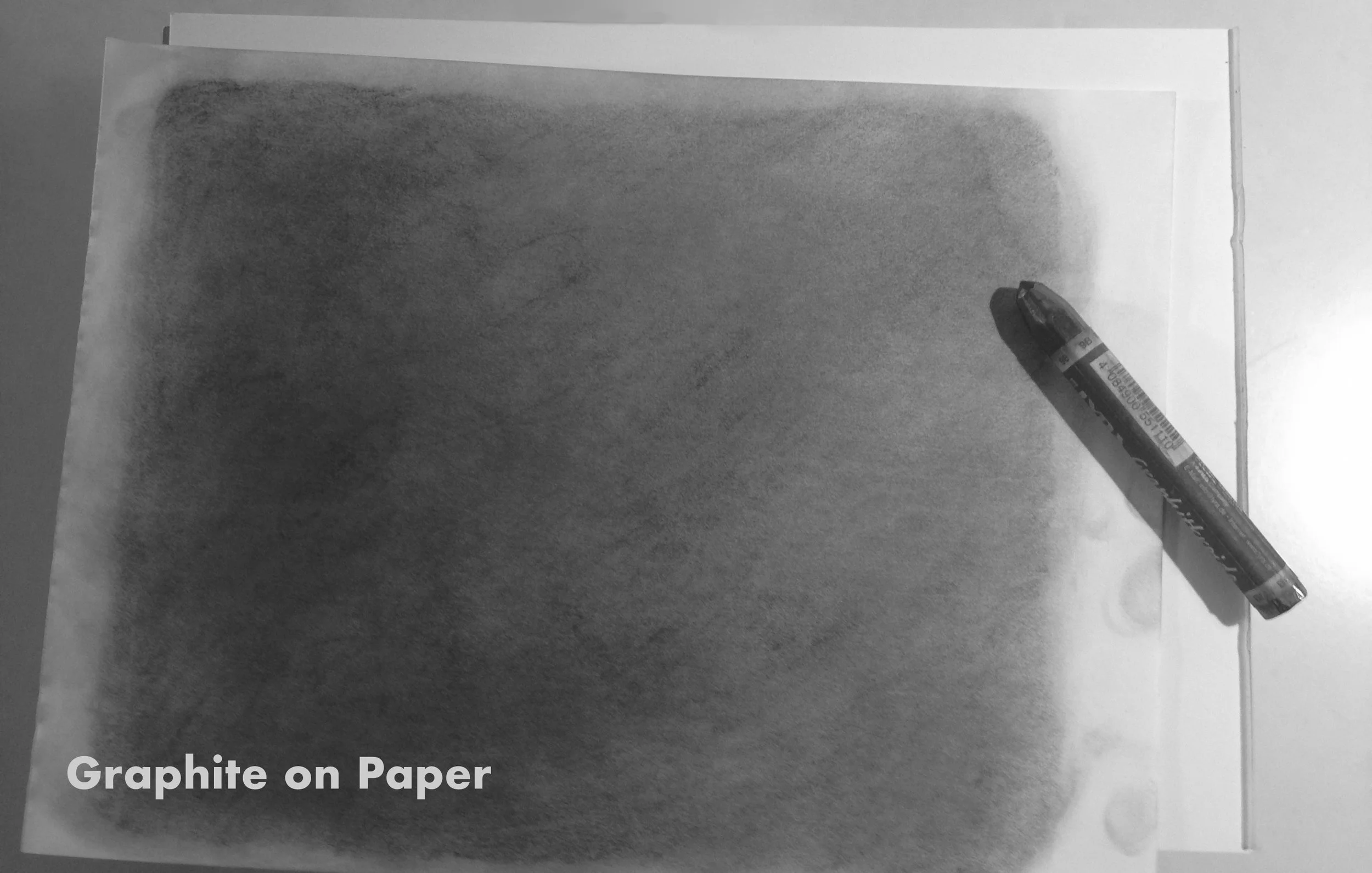 Here is a sheet of paper that I have covered evenly with graphite. This texture is then scanned into the computer and used as a layer on top of my illustration to add a visual grain.