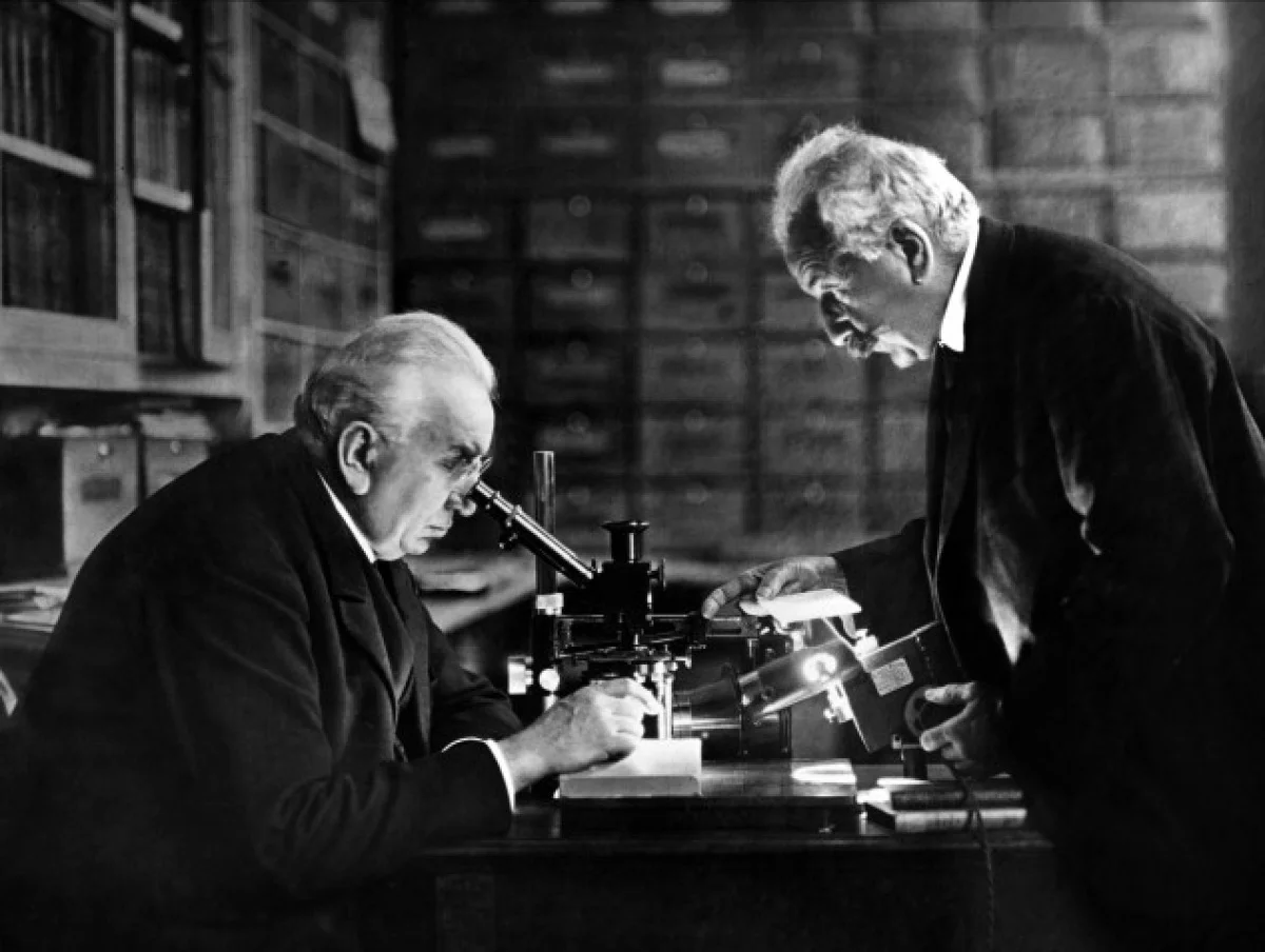The Lumiere Brothers, Auguste and Louis, showing their invention to scientists (1895).