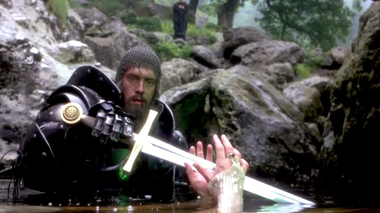 King Arthur retrieves His talismanic sword from a spirit in a lake in the film Excalibur (1981)
