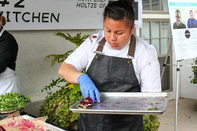 Josslyn from Team Harvest Kitchen plating their amazing Poached Beet Stack 