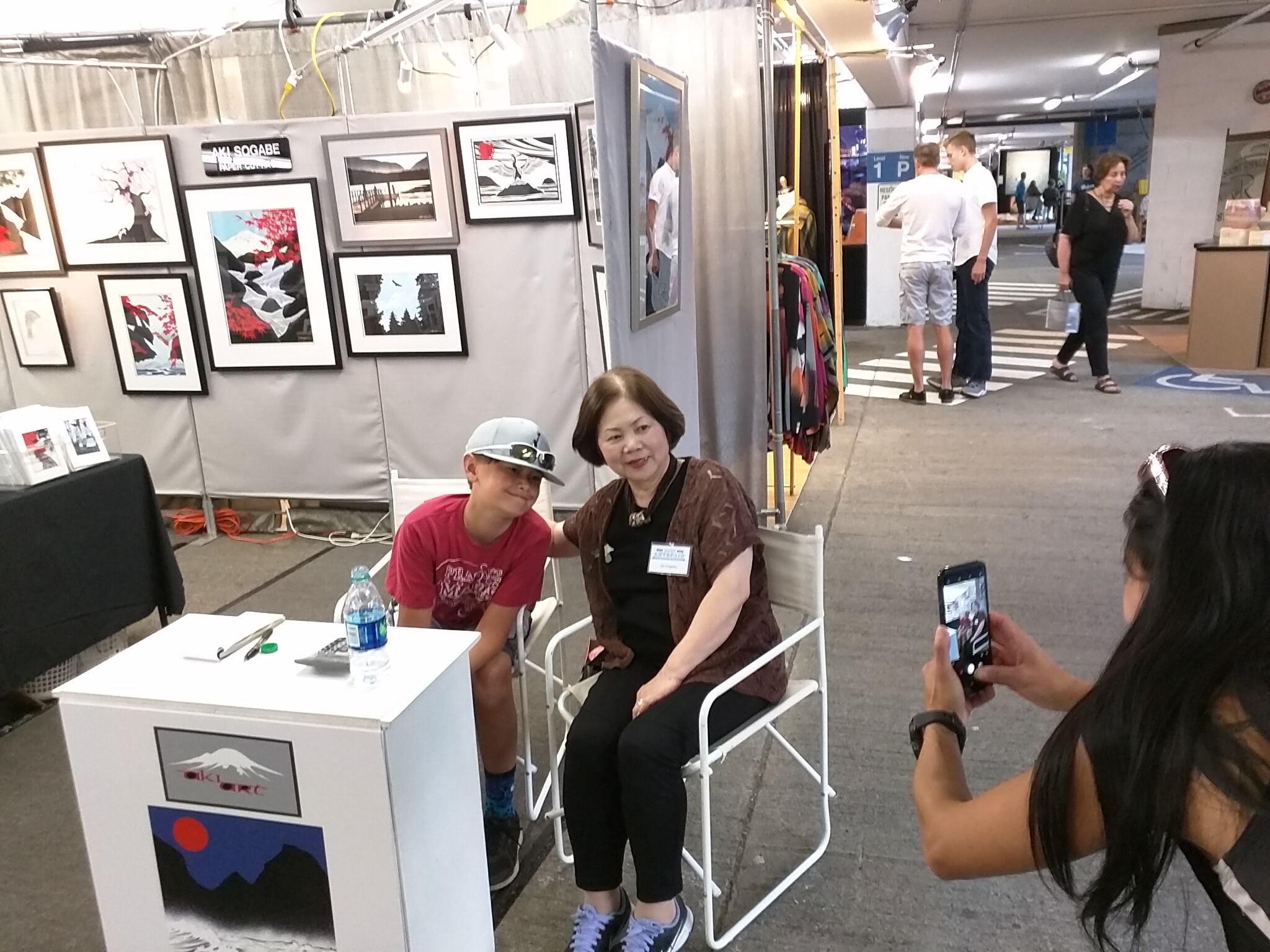 Aki with her grandson Keaton and some crazy woman taking their picture.