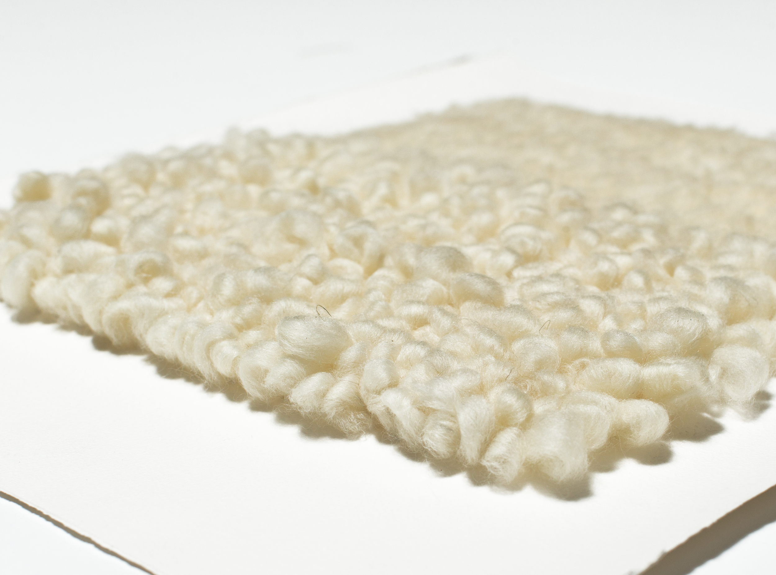  Tufting is a technique traditionally used through open weave fabric for rug making. These 3 dimensional wall pieces are created using the same tufting form through cotton paper.  yarn : wool roving 