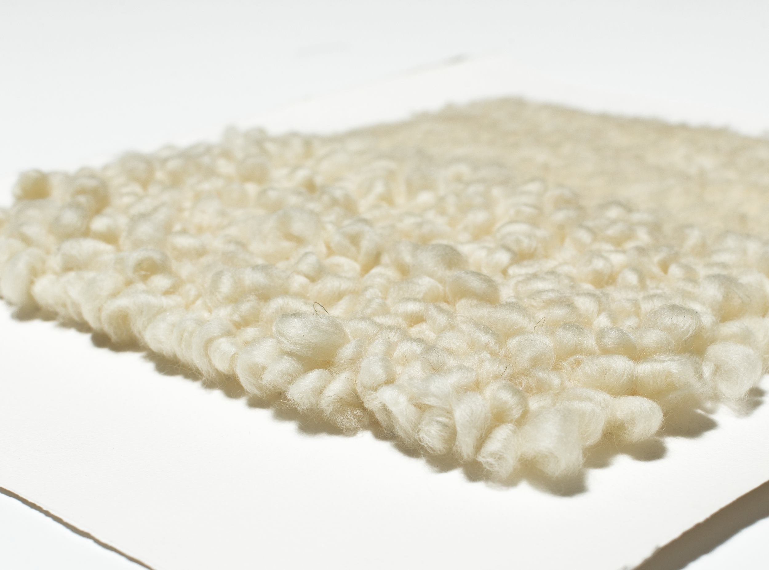 Tufting is a technique traditionally used through open weave fabric for rug making. These 3 dimensional wall pieces are created using the same tufting form through cotton paper. yarn : wool roving