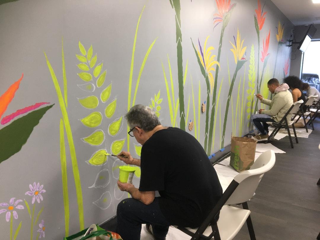 Jose Luis Ortiz and men painting the mural