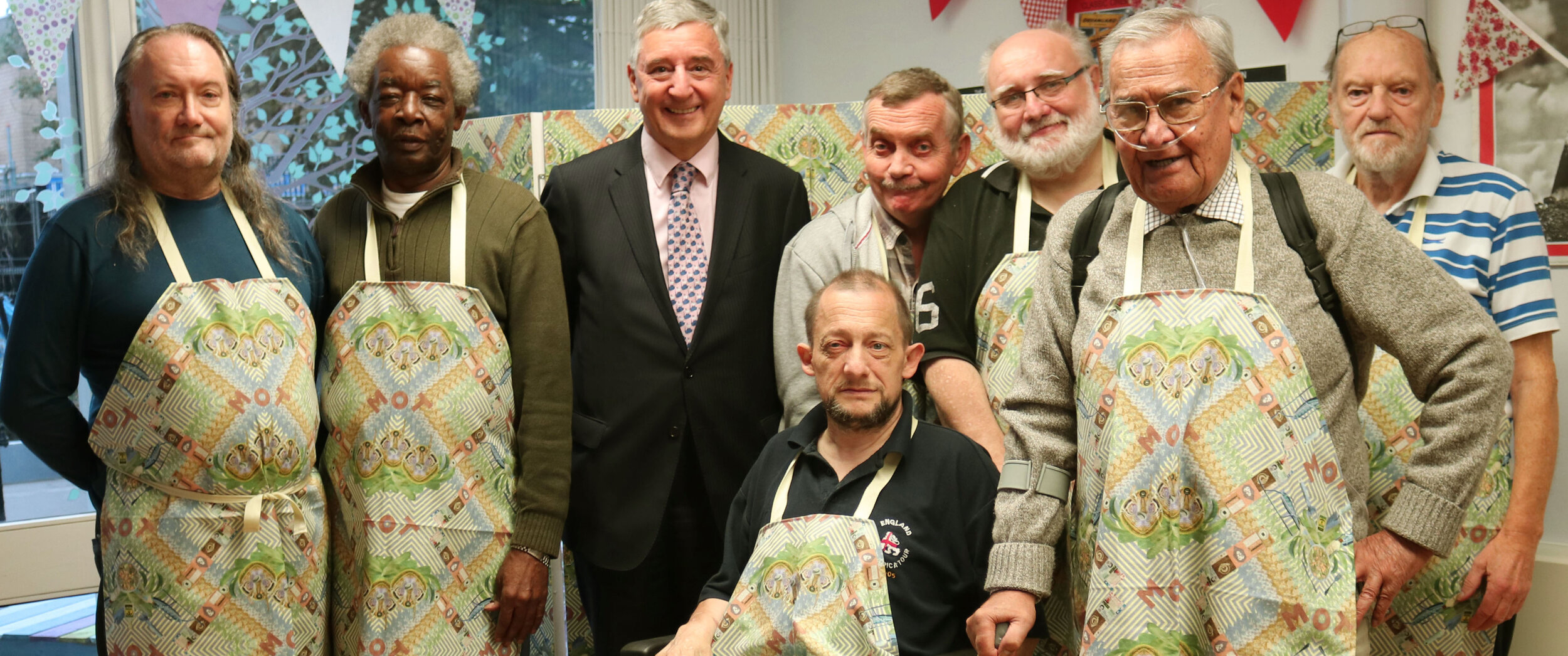 The Men's Cabin with MP Jim Fitzpatrick. Left to right = Rex; Clifton; (MP Jim Fitzpatrick); Dave; Paul (in wheelchair); Brian; Joseph; George.JPG