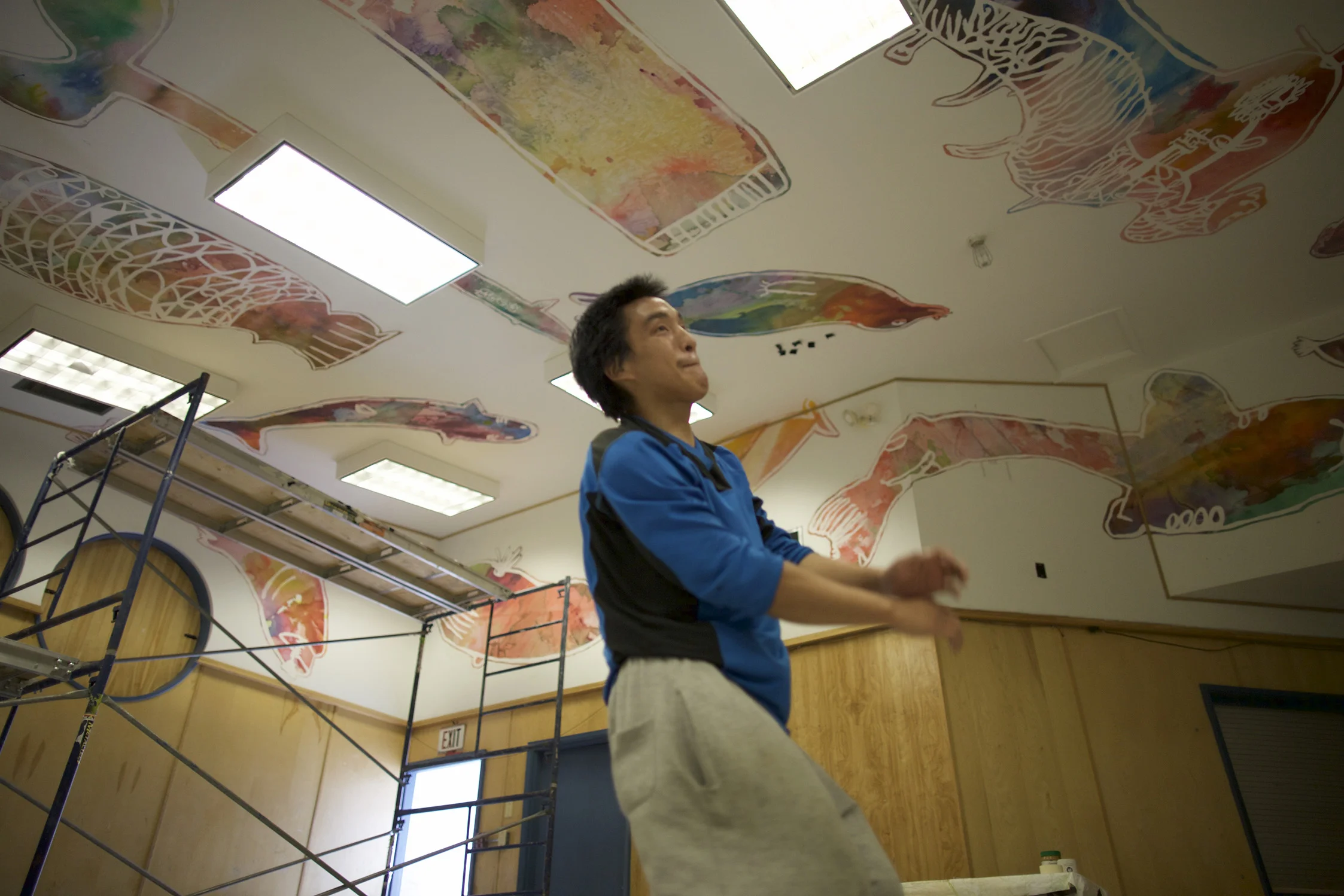Installing the mural makes Iqaluk break into dance! 