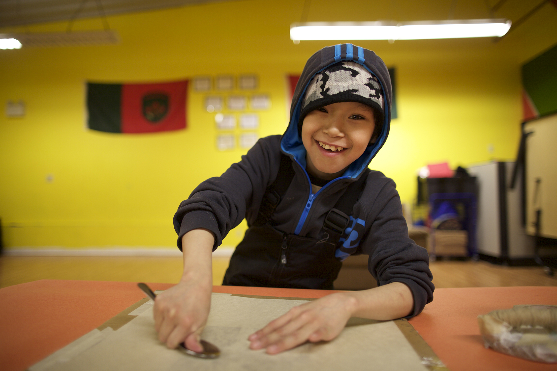 Moe happily hand-printing his linocut. Moe's dad Ashoona Ashoona is a distinguished stonecut printer at Kinngait Studios.