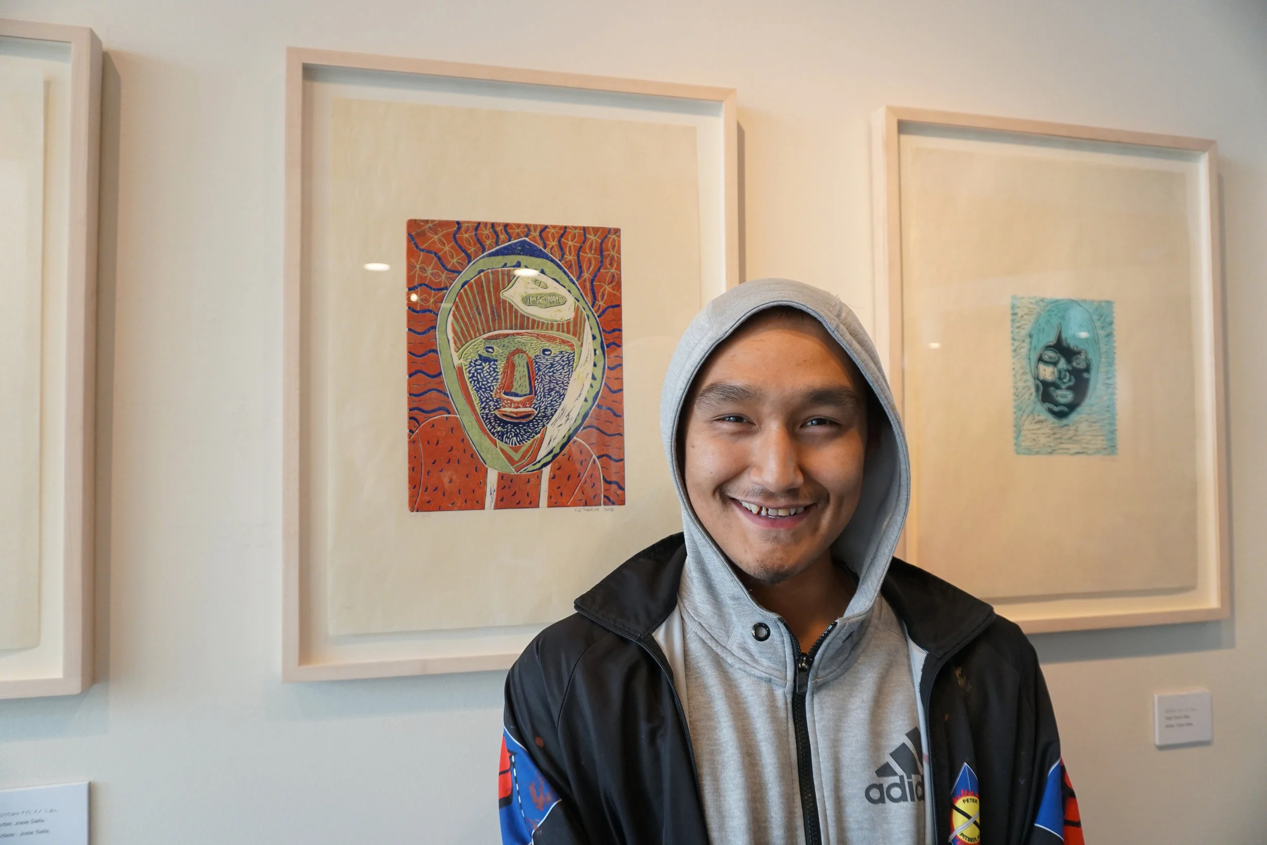 Cie Taqiasuk with his reductive linocut self-portrait