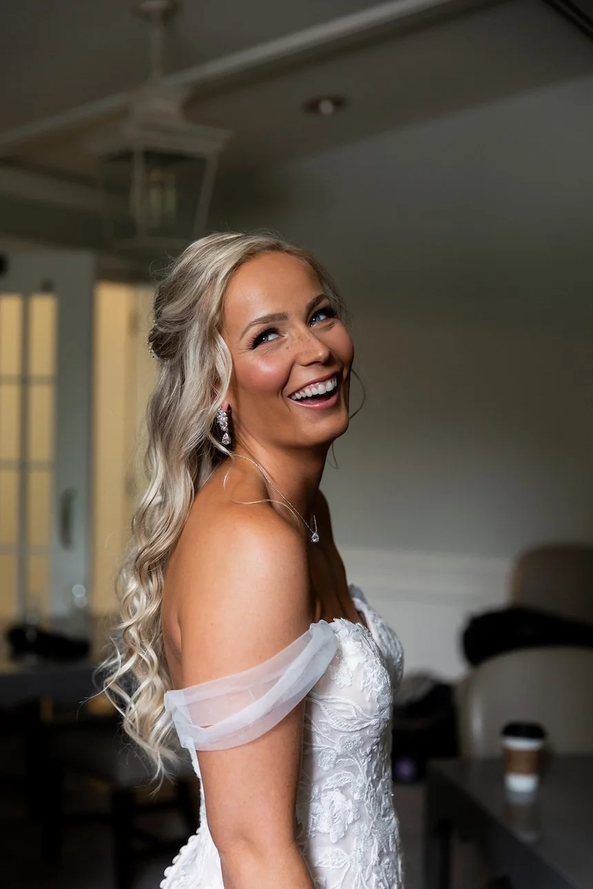 bride smiling big as she gets ready to have a first look with her groom