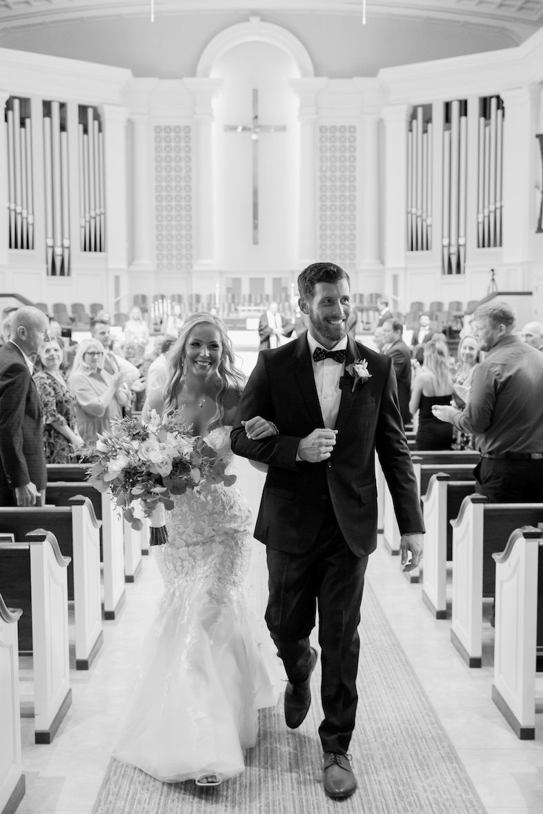 bride and groom exit a tradition church ceremony moments after they say I do