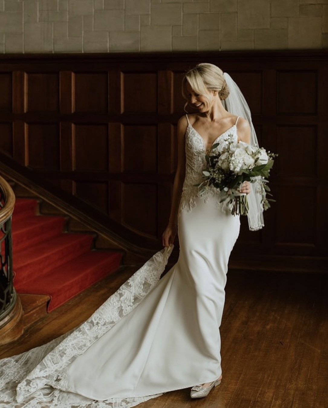 elegant lace bridal gown with clean floral bouquet and classic bridal updo