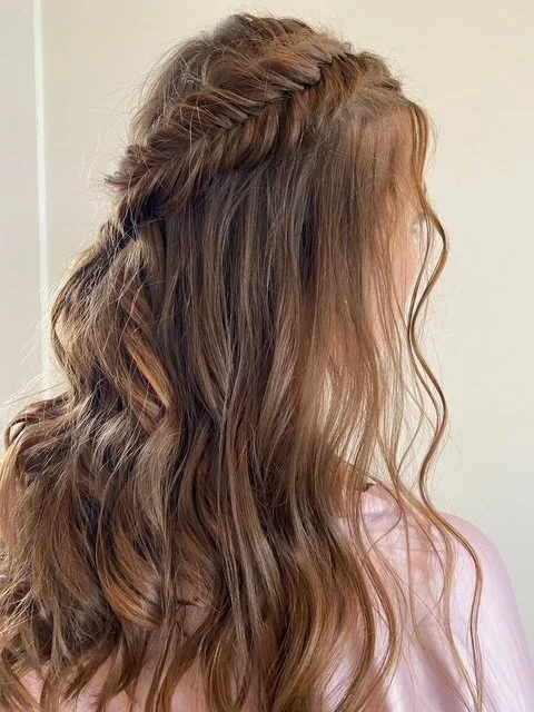 brunette with fine hair wearing a half-up half-down hairstyle with a braid
