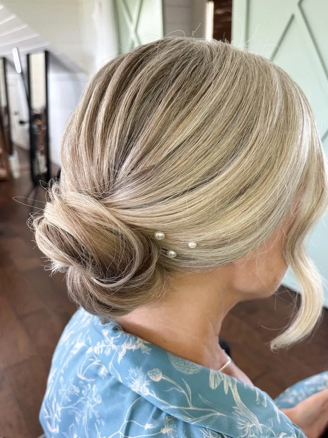bride with fine blonde hair is wearing an updo on her wedding day