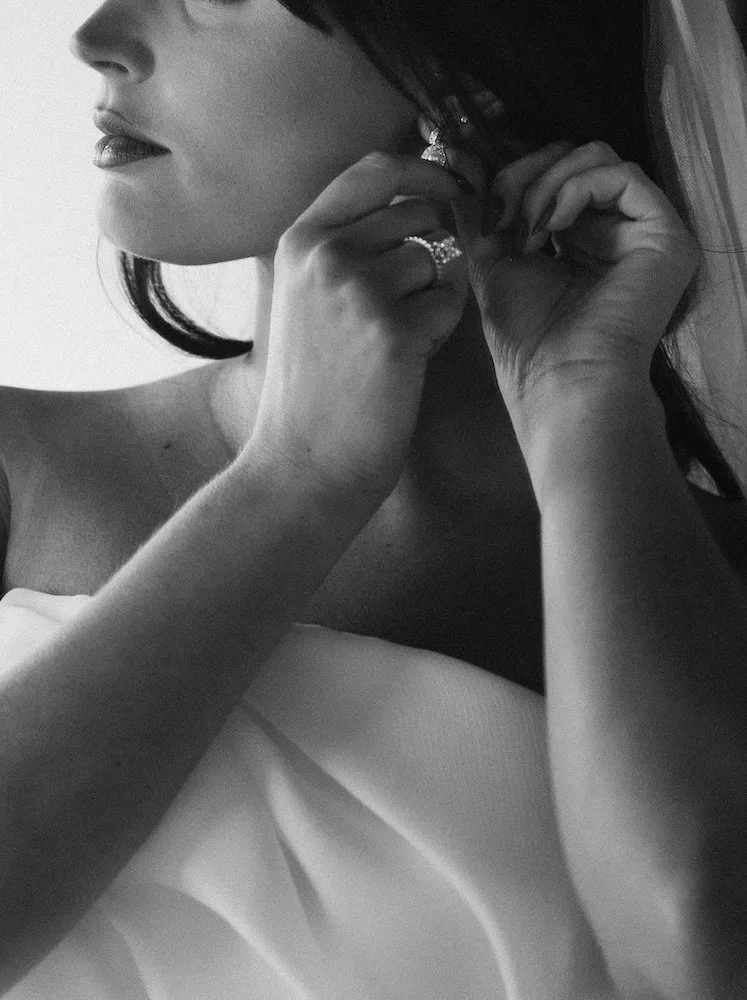 black and white photo of a bride hair makeup and wedding gown on
