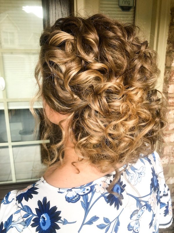 updo with natural curls on brunette hair