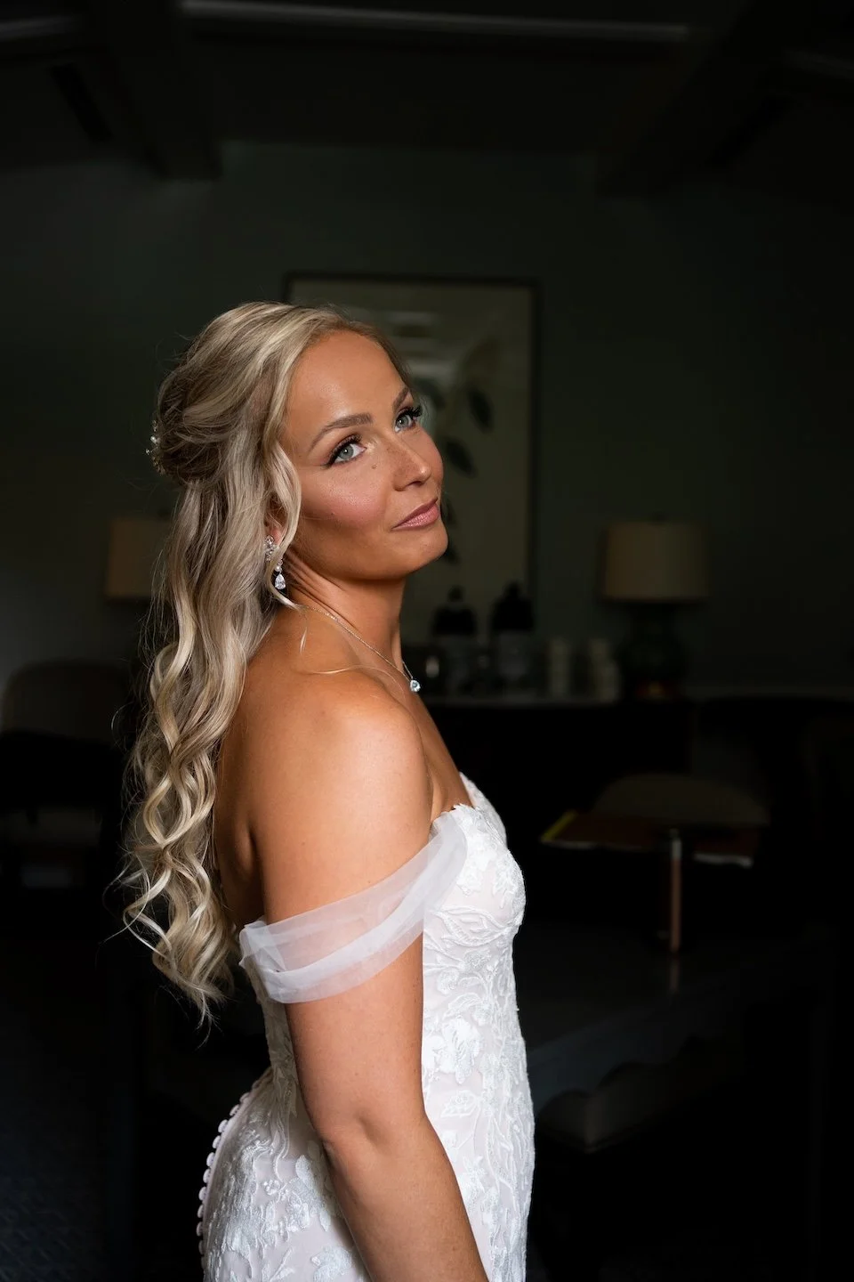 close up photo of a blonde hair bride with a half up half down hairstyle and flawless soft glam wedding makeup