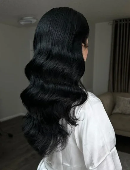 glam wave hairstyle on jet black hair color