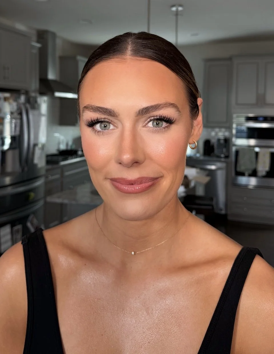 natural bridal makeup photo of a bride with dark brown hair and blue eyes