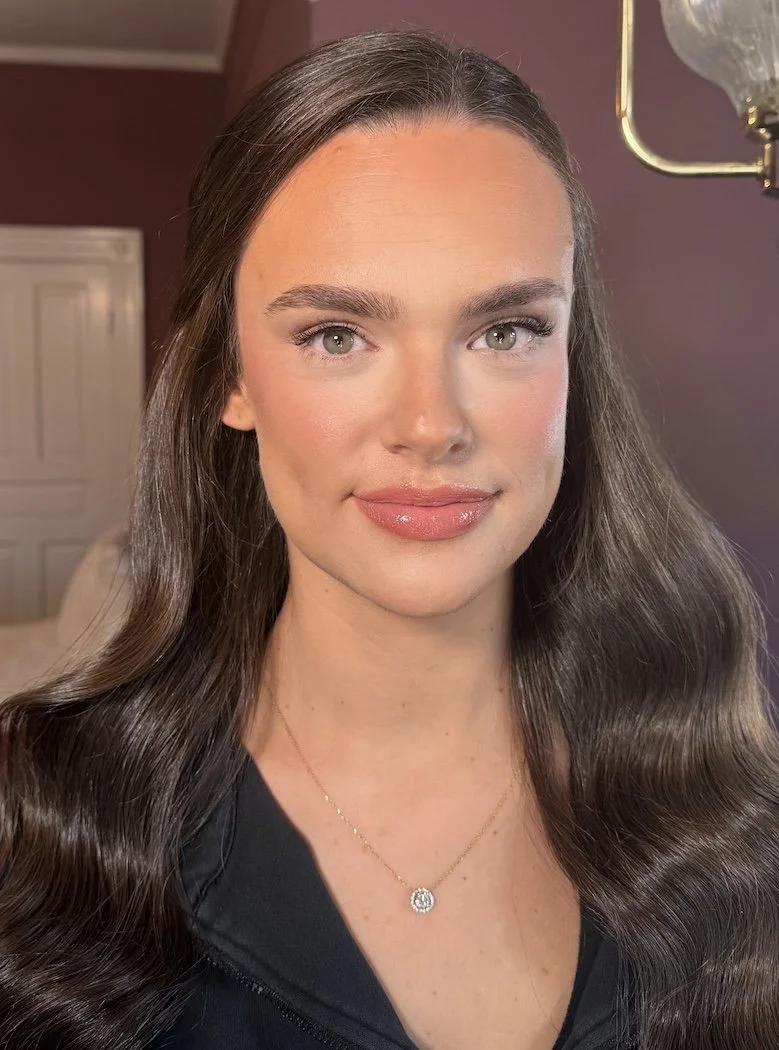 close up photo of a bride with brown hair tan skin and green eyes wearing natural makeup