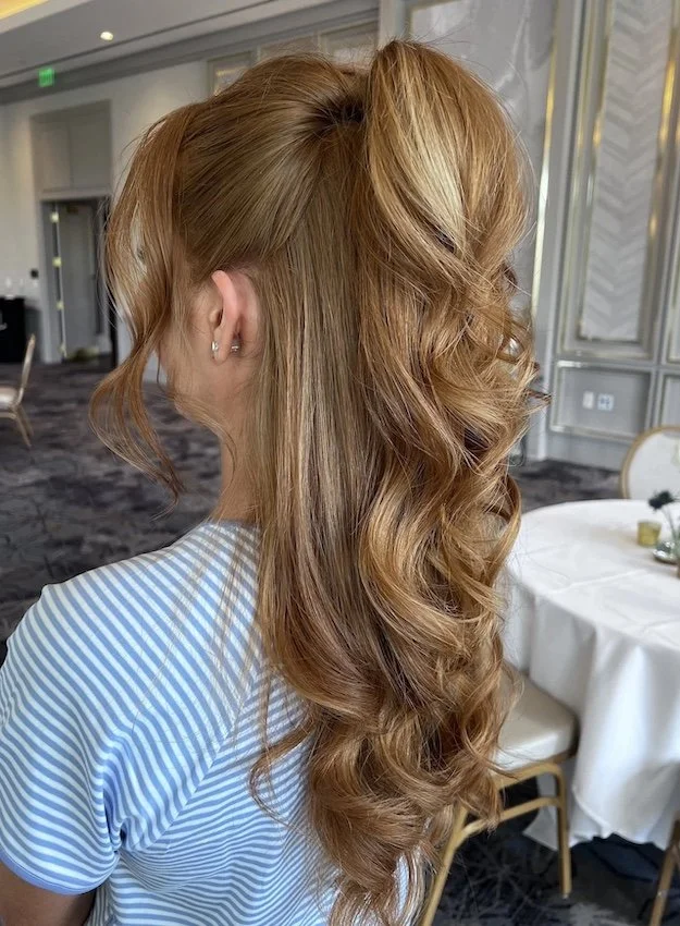 modern half up half down hairstyle on vibrant long red hair